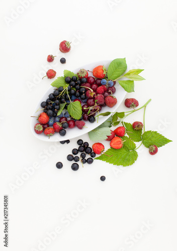 Strawberry, currant, gooseberry, cherry, raspberry on white background with leaves