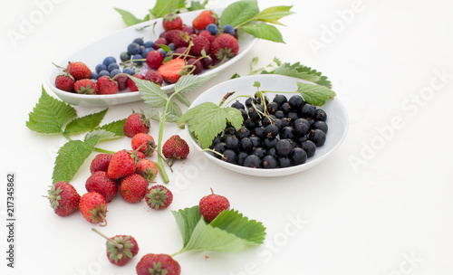 Strawberry, currant, gooseberry, cherry, raspberry on white background with leaves