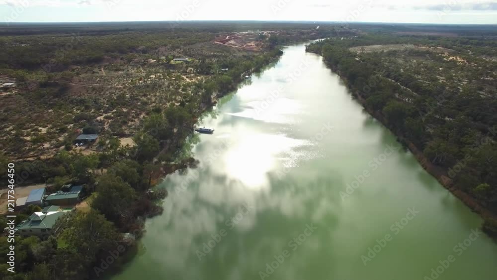 Backward flight along Murray River on bright sunny day with clouds reflecting in calm water Backward flight along Murray River on bright sunny day with clouds reflecting in calm water