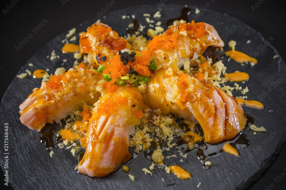 Salmon Nigiri, Sushi salmon burned and topped with Shrimp Eggs and Tempura, Japanese food style, Japanese Food menu, selective focus Salmon Nigiri, Sushi salmon burned and topped with Shrimp Eggs and Tempura, Japanese food style, Japanese Food menu, selective focus