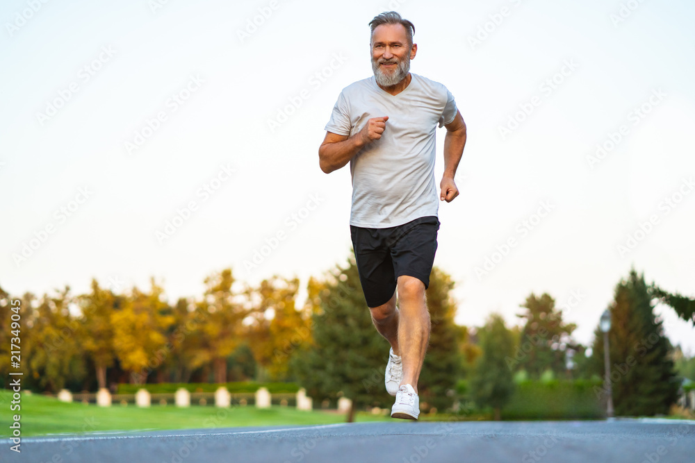The smiling happy elderly man running on the road Stock Photo Adobe Stock