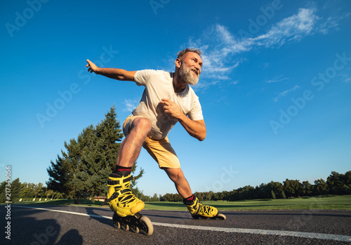 The old man rollerblading on the road