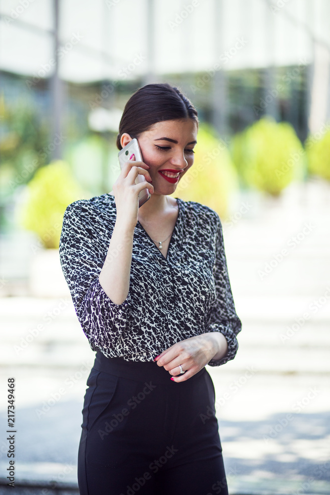 Fototapeta premium Businesswoman walk in city financial district and talking on phone