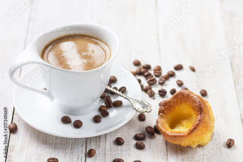 A cup of hot coffee with a yorkshire pudding on a white wooden background. Breakfast. Copy Space. © photography