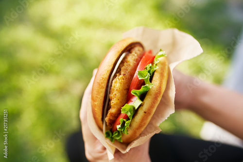 woman holding crispy chicken sandwich from first person view