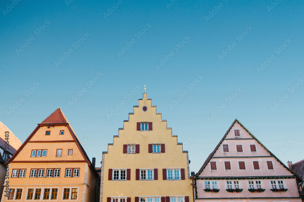 Multicolored houses with many windows against the blue sky in Rothenburg ob der Tauber in Germany. Multicolored houses with many windows against the blue sky in Rothenburg ob der Tauber in Germany.