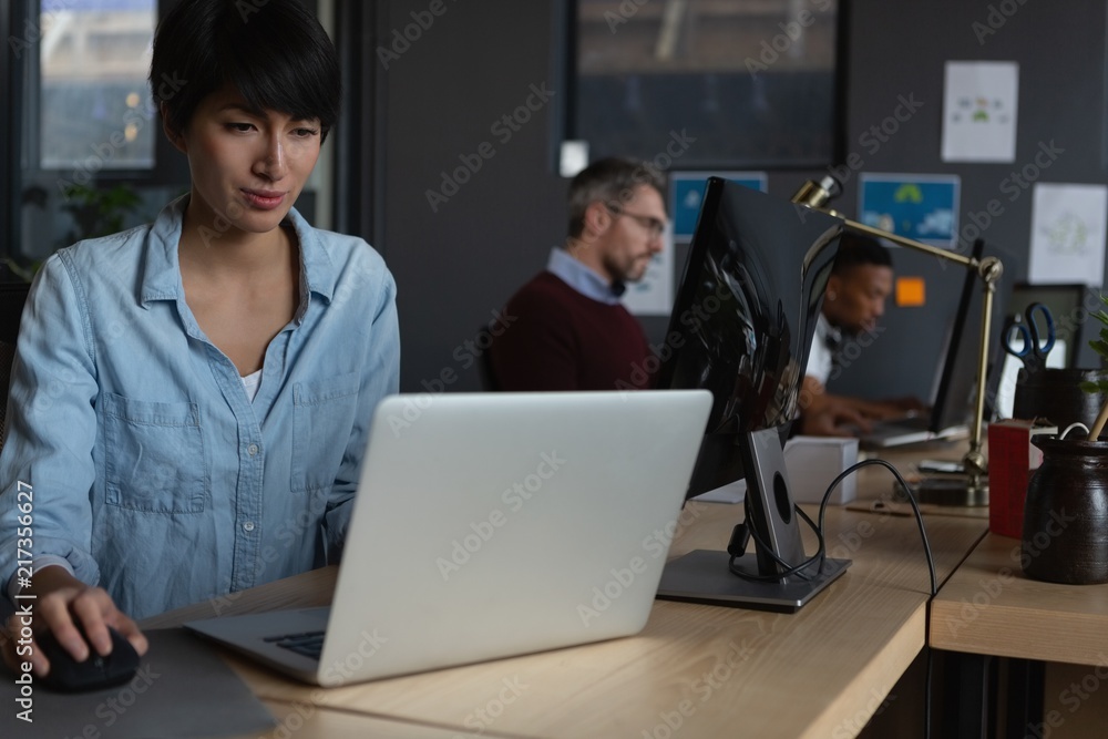 Colleagues working at desk in the office Colleagues working at desk in the office