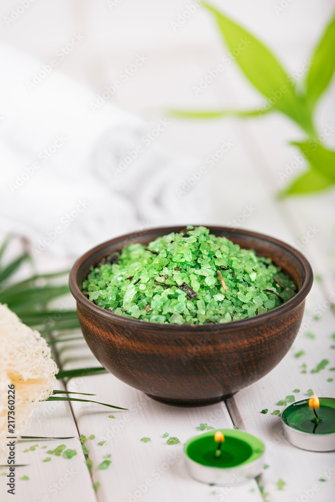 Spa. Green herbal spirulina salt in ceramic bowl, spa towels, candles and bamboo Spa. Green herbal spirulina salt in ceramic bowl, spa towels, candles and bamboo