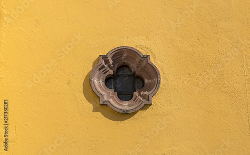 Mexican colonial peculiar winow with yellow wall in San Miguel de Allende Mexico photo