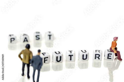 words past blurred and future sharp on white background with miniature figurines