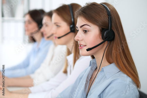 Call center operator.Young beautiful brunette woman in headset. Business concept