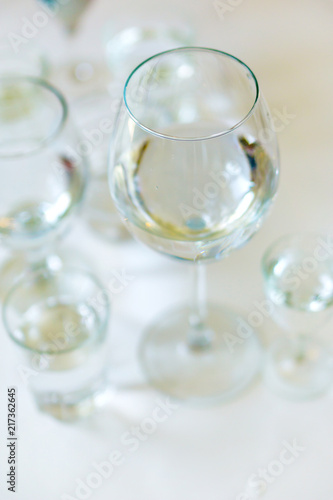 Close-up of glasses of crystal clear drinking water on a white table. Shallow depth of focus. Health concept from nature.