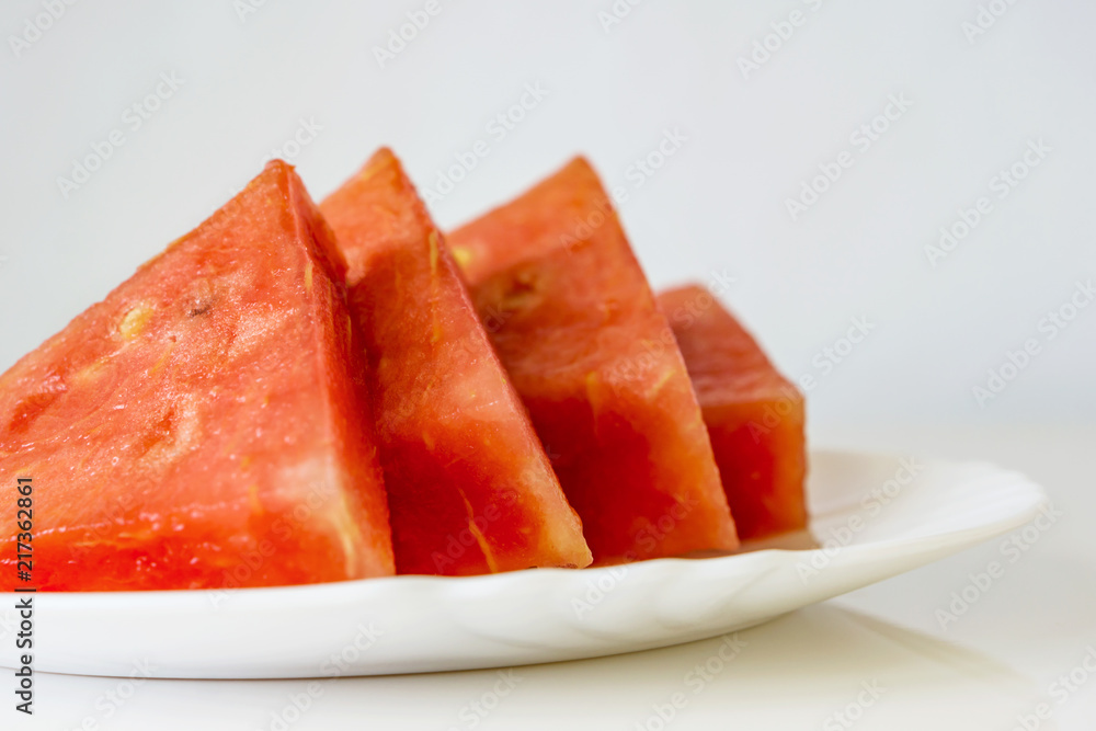 Close up of fresh, red watermelon, on a white background. Summer flavor. Shallow depth of focus. Close up of fresh, red watermelon, on a white background. Summer flavor. Shallow depth of focus.