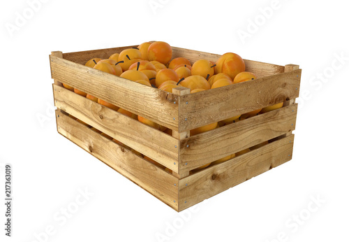 Wooden box full of peach fruit. Isolated on white background.