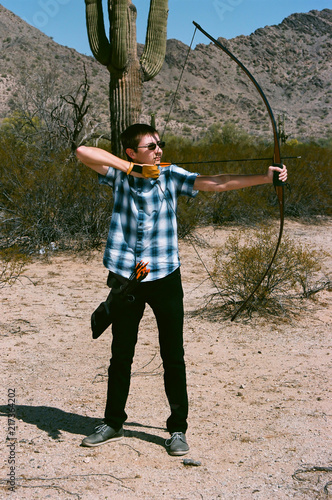 The Traditional Archer with a long bow in the desert