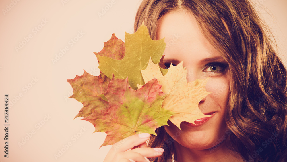 Pretty autumnal girl with maple leaves in hand Pretty autumnal girl with maple leaves in hand
