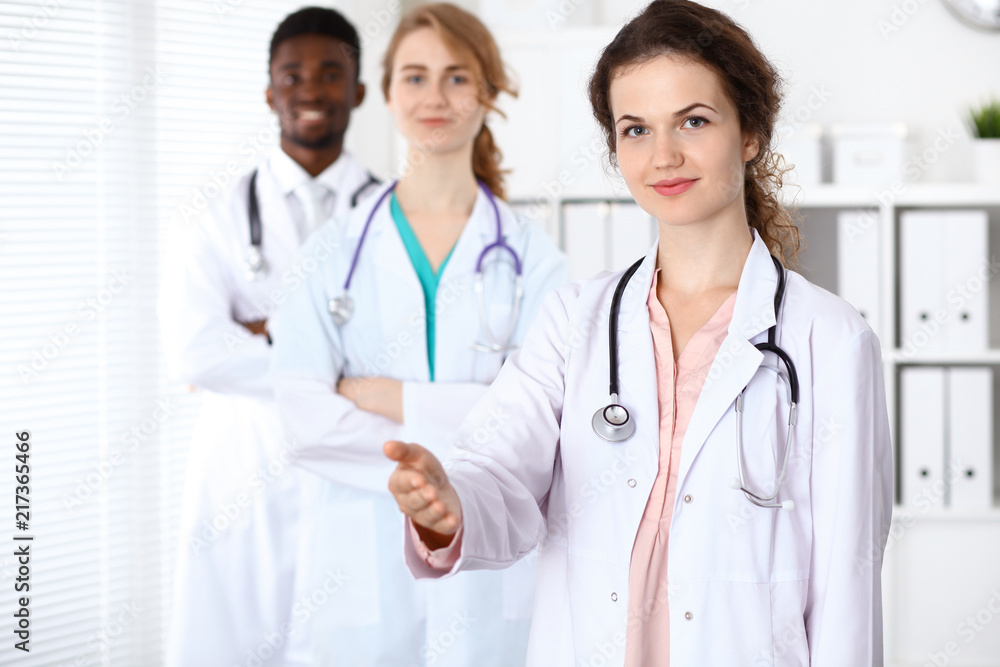 Medical team of confident doctors showing Ok sign with thumbs up. Medicine and health care, insurance concept Medical team of confident doctors showing Ok sign with thumbs up. Medicine and health care, insurance concept