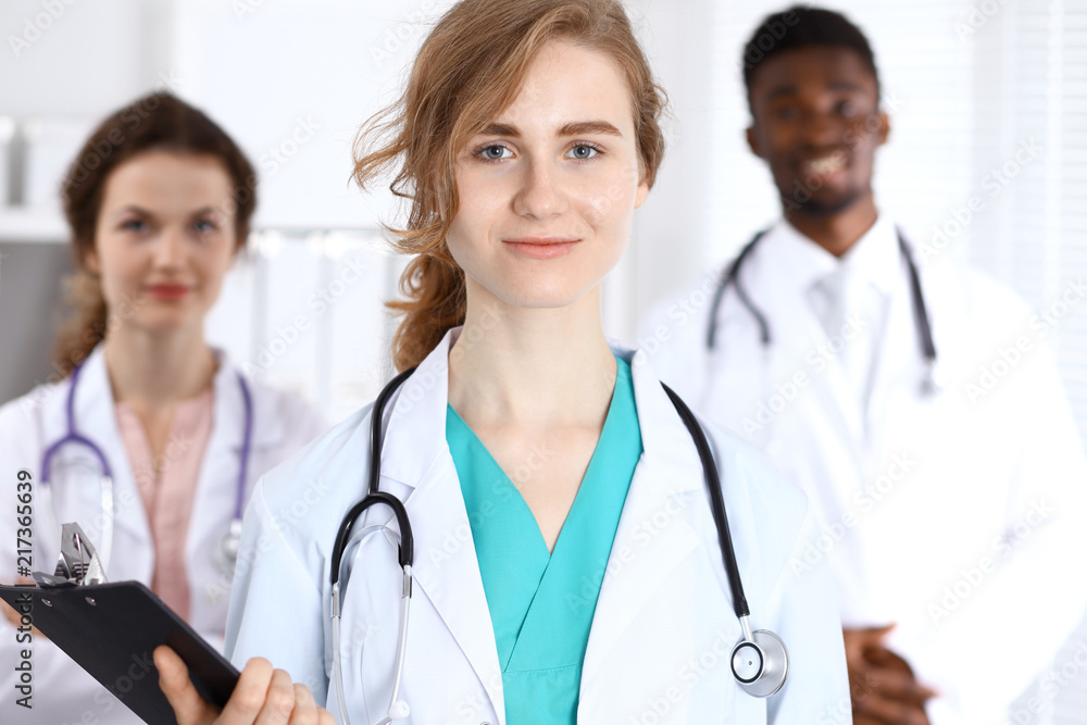 Happy doctor woman with medical staff at the hospital Happy doctor woman with medical staff at the hospital