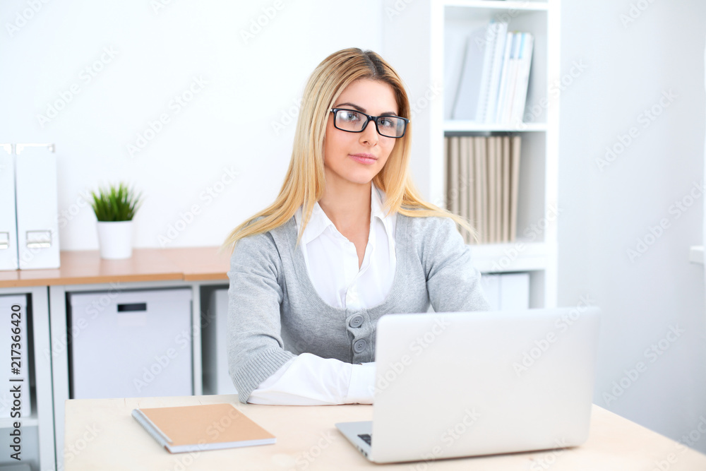Young business woman or student girl working at office workplace with laptop computer Young business woman or student girl working at office workplace with laptop computer