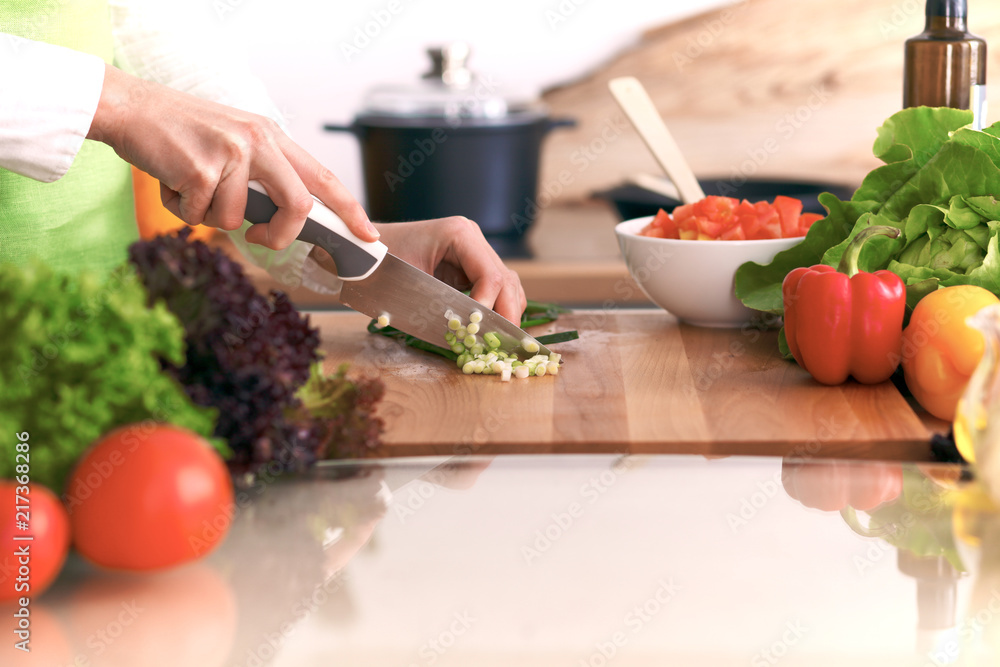 Close Up of human hands cooking vegetable salad in kitchen on the glass table with reflection. Healthy meal, and vegetarian food concept Close Up of human hands cooking vegetable salad in kitchen on the glass table with reflection. Healthy meal, and vegetarian food concept