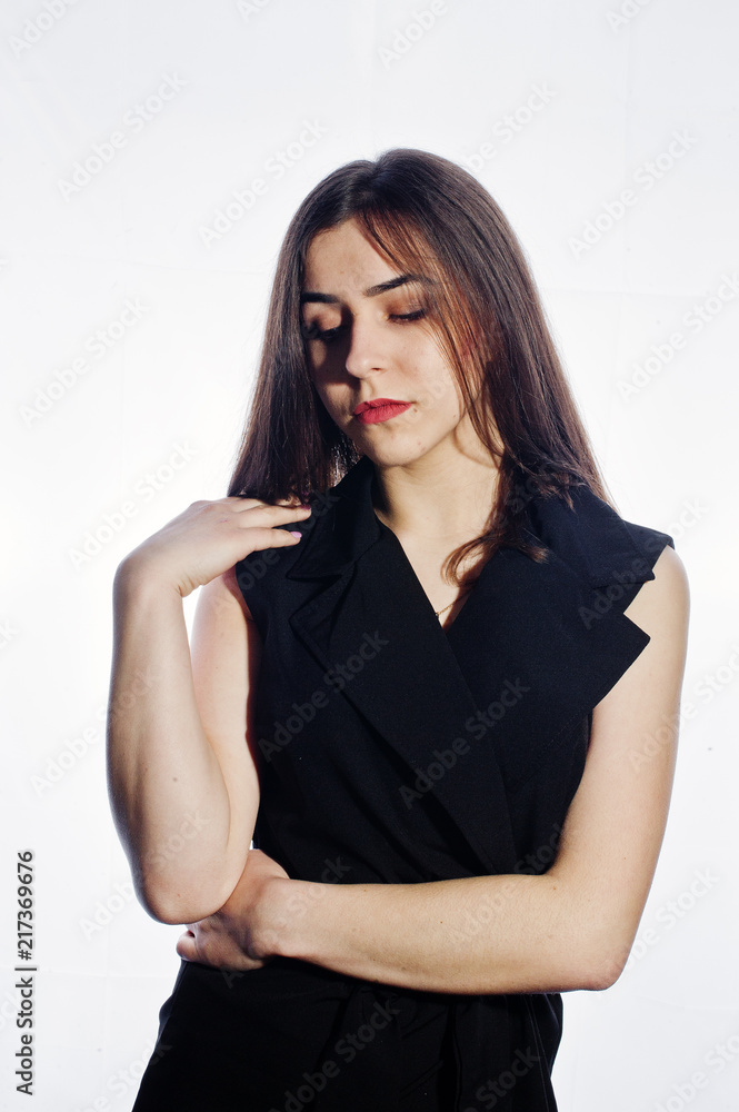 Close-up emotional portrait of a brunette girl in black jumpsuit on white background. Close-up emotional portrait of a brunette girl in black jumpsuit on white background.