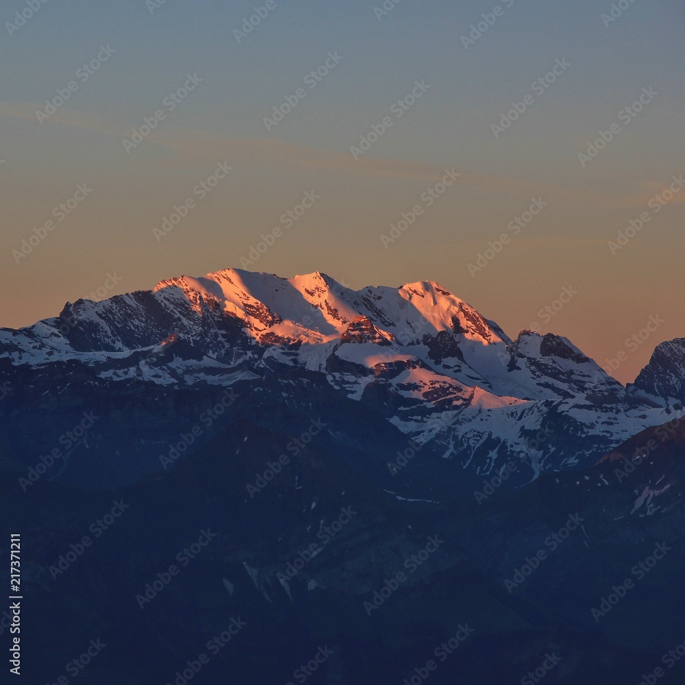 Snow capped mountain Blüemlisalp at sunrise. View from Mount Niederhorn. Bernese Oberland, Switzerland.
