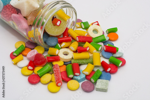 Colorful candy in a jar on a white background photo