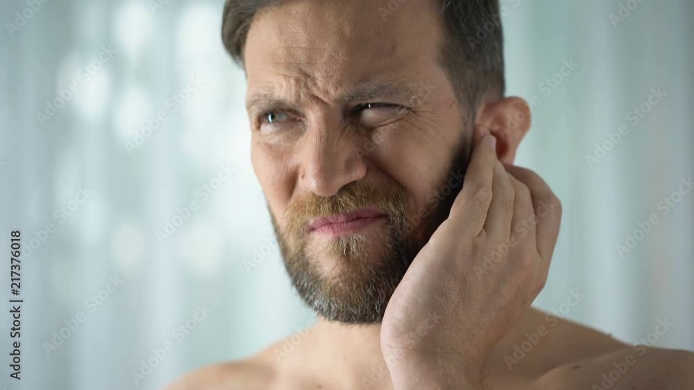 Sick guy feeling ear pain, health care, neurological infection, itchiness otitis Sick guy feeling ear pain, health care, neurological infection, itchiness otitis