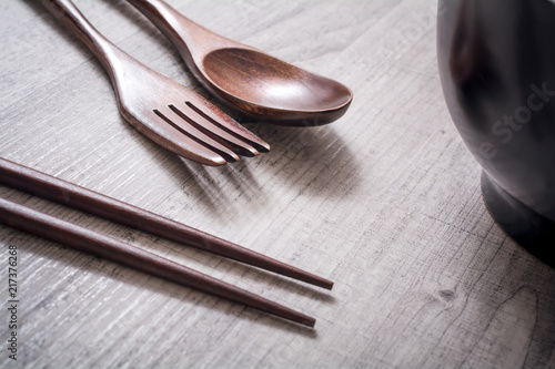 Wooden Set Of Fork, Knife And Chopsticks Next To A Bowl On A Table - Eating Chinese Food Concept