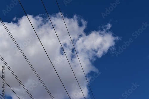 Overhead wire cables in the clouds