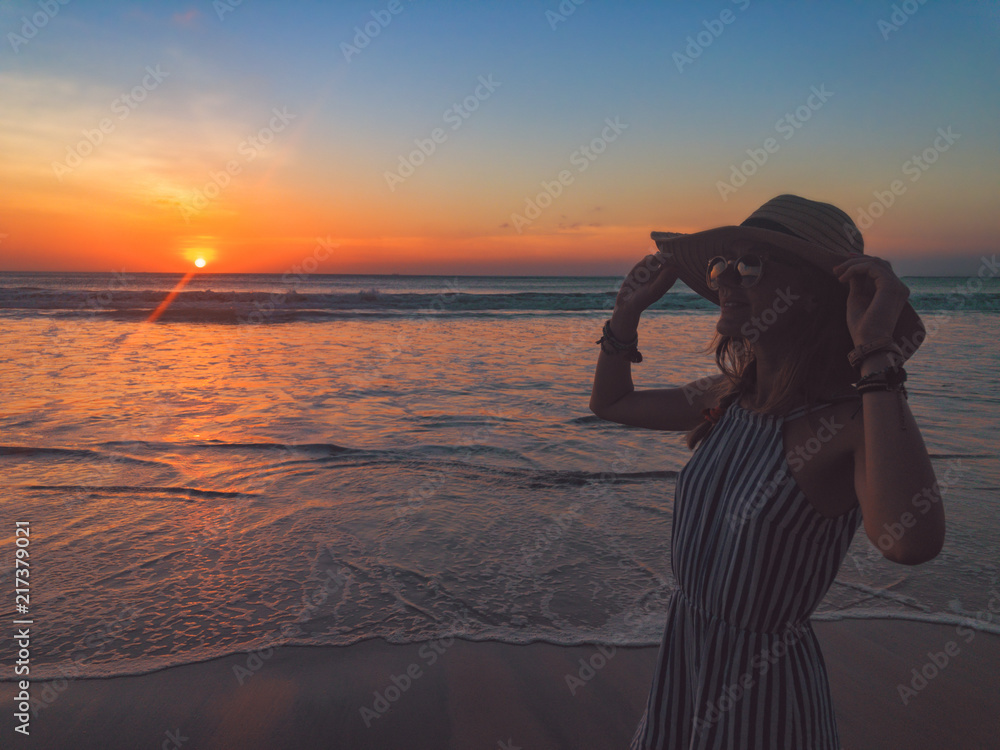 Silhouette of a girl in sunset / sunrise time over the ocean.