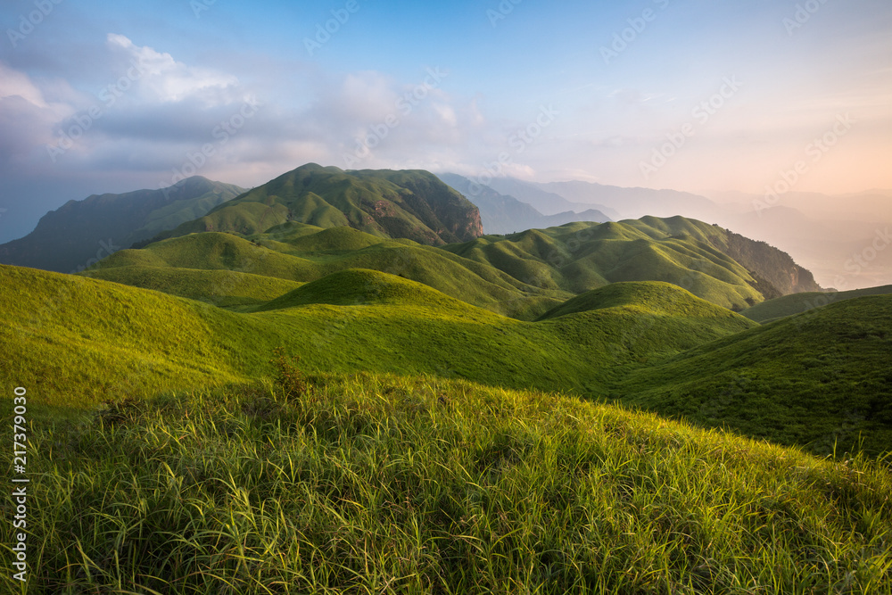 Fototapeta premium Pingxiang Wugong Mountain Scenery in Jiangxi Province, China. Lush green alpine grassland, alpine meadow sunset. Exotic Mountains of China, Wugong Shan National Park of China. Hiking Camping