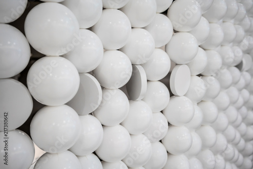 Small white spheres and flat circle shapes wall for Interior design.