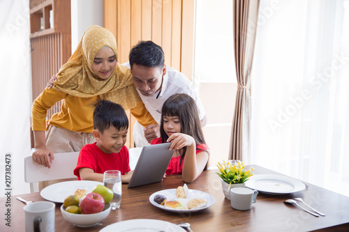 family using tablet pc at home