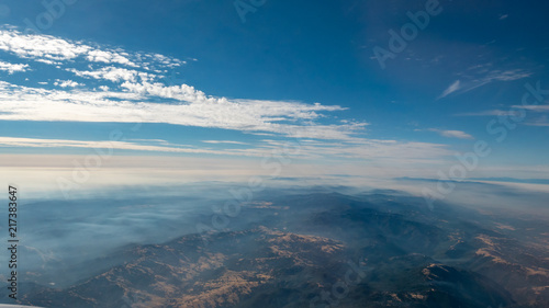 Aerial View of Mountain Formation with Low Clouds During daytime