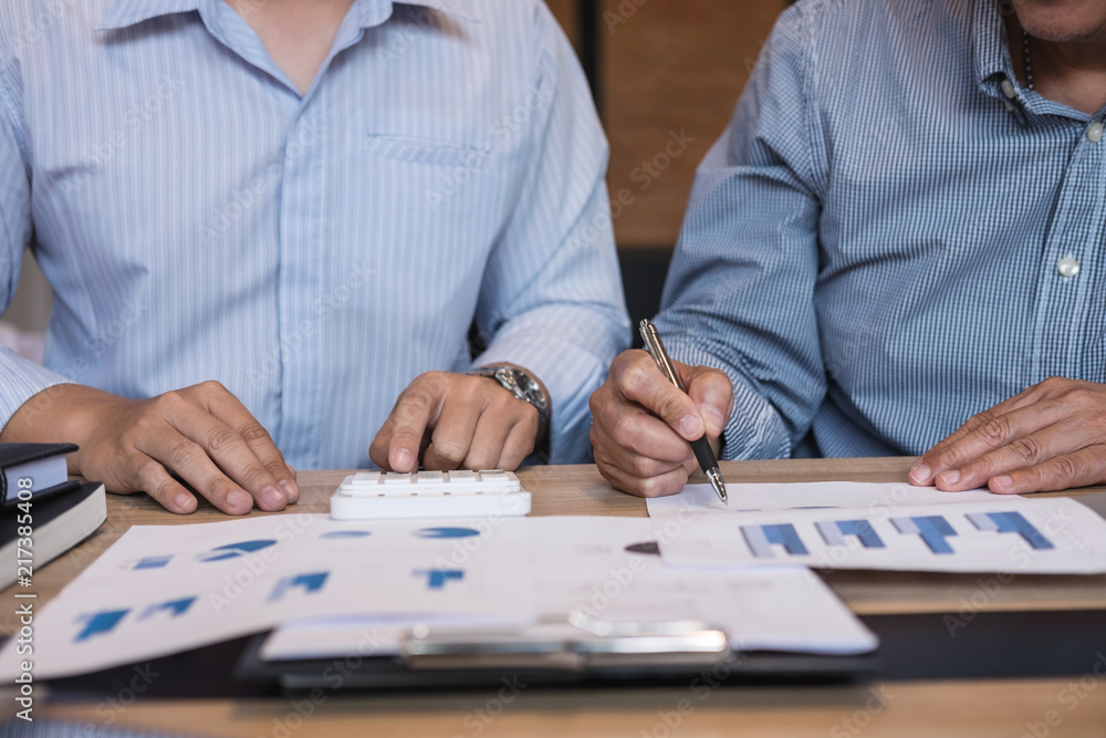 Business team two executive colleagues discussing and analysis working Financial investment on calculator with calculate on tablet Analyze business and market growth on financial document data graph Business team two executive colleagues discussing and analysis working Financial investment on calculator with calculate on tablet Analyze business and market growth on financial document data graph