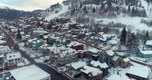 Aerial drone shot flying backwards over Park City in Utah during a winter day at Sundance Film Festival photo