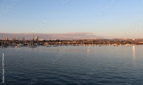 Newport Beach Harbor at dusk with clouds from fire on the horizon