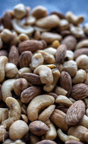 Pile of mixed nut on a blue background