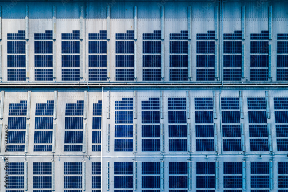 aerial view of factory roof with solar panels aerial view of factory roof with solar panels