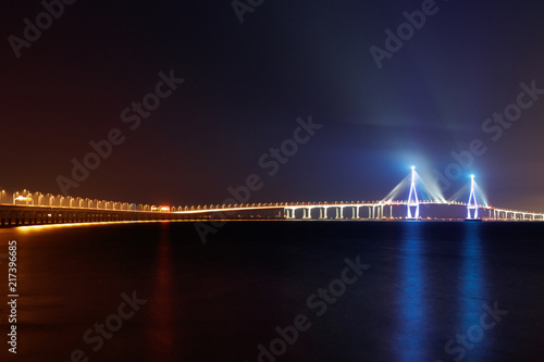 Incheon Bridge night scenery. Incheon Bridge Night view of various colors. Reflections on the sea. Incheon Bridge to Incheon Airport. Republic of Korea. photo