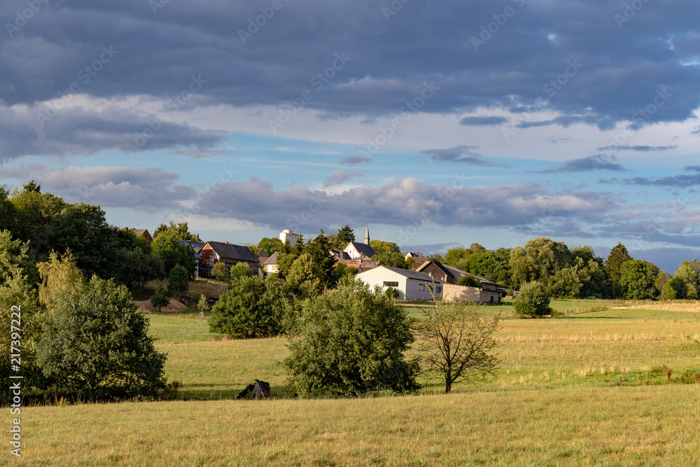 Small village in a rural landscape under blue sky in summer
