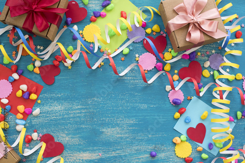 Decorative holiday background with streamers confetti candy hearts decor.