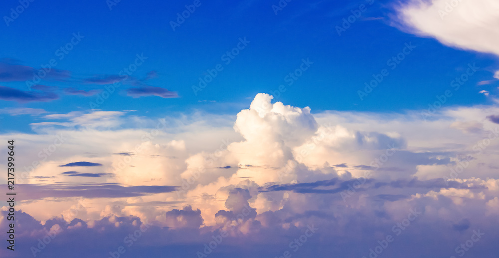 Colorful curly clouds in the blue sky during the sunset _