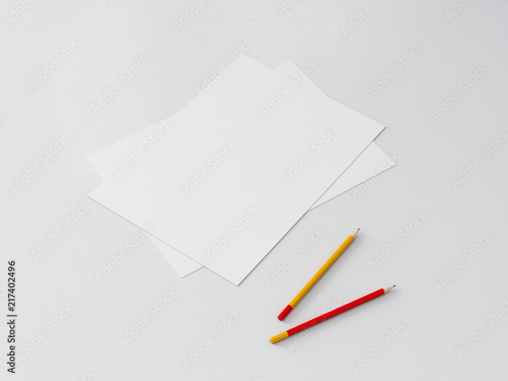 Two Paper sheets with pencils on white table Two Paper sheets with pencils on white table