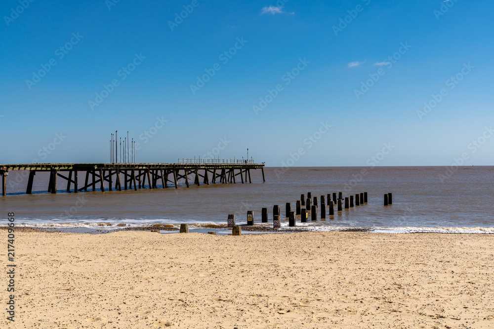 North Sea coast in Kirkley, Lowestoft, Suffolk, England, UK with the Claremont Pier and a wave breaker