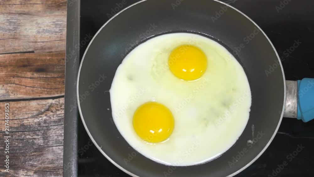 Cooking sunny side up eggs for breakfast. Close up slider shot. Cooking sunny side up eggs for breakfast. Close up slider shot.