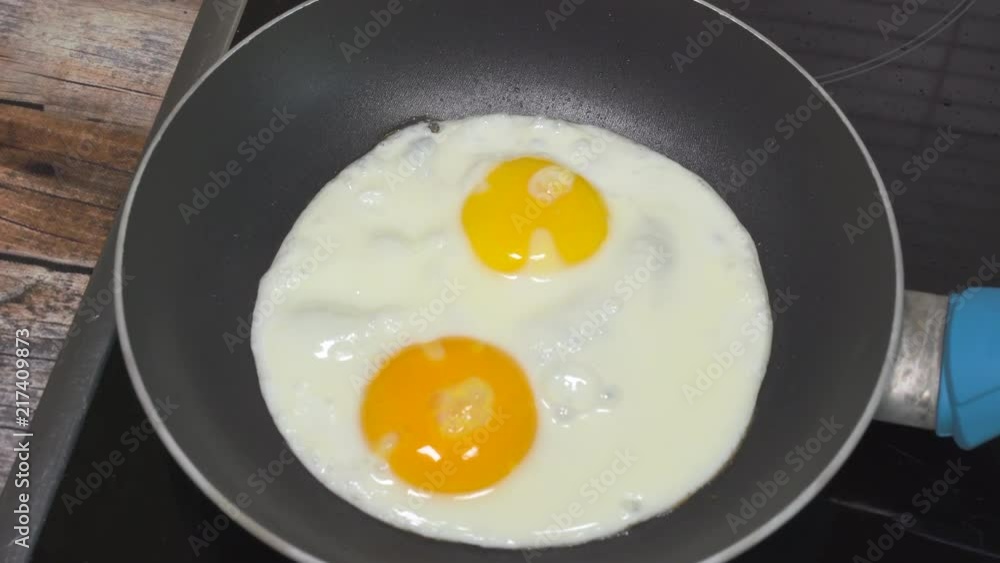 Cooking sunny side up eggs for breakfast. Close up slider shot. Cooking sunny side up eggs for breakfast. Close up slider shot.
