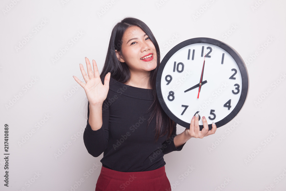 Happy Young Asian woman with a clock. Happy Young Asian woman with a clock.