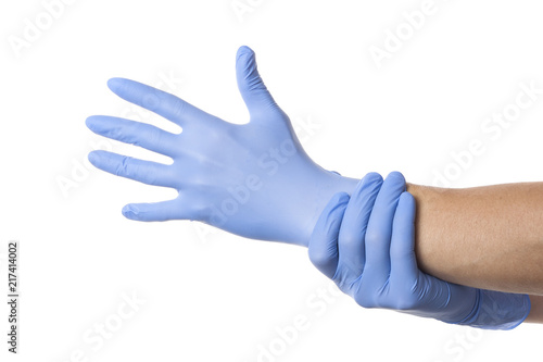 Fototapeta Naklejka Na Ścianę i Meble -  Doctor putting on sterile gloves isolated on white